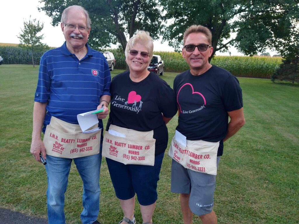 Pastor Phil Peterson, Nancy Peterson, and Shane Marik volunteering at the 2024 SLCW Pork Chop dinner outreach.