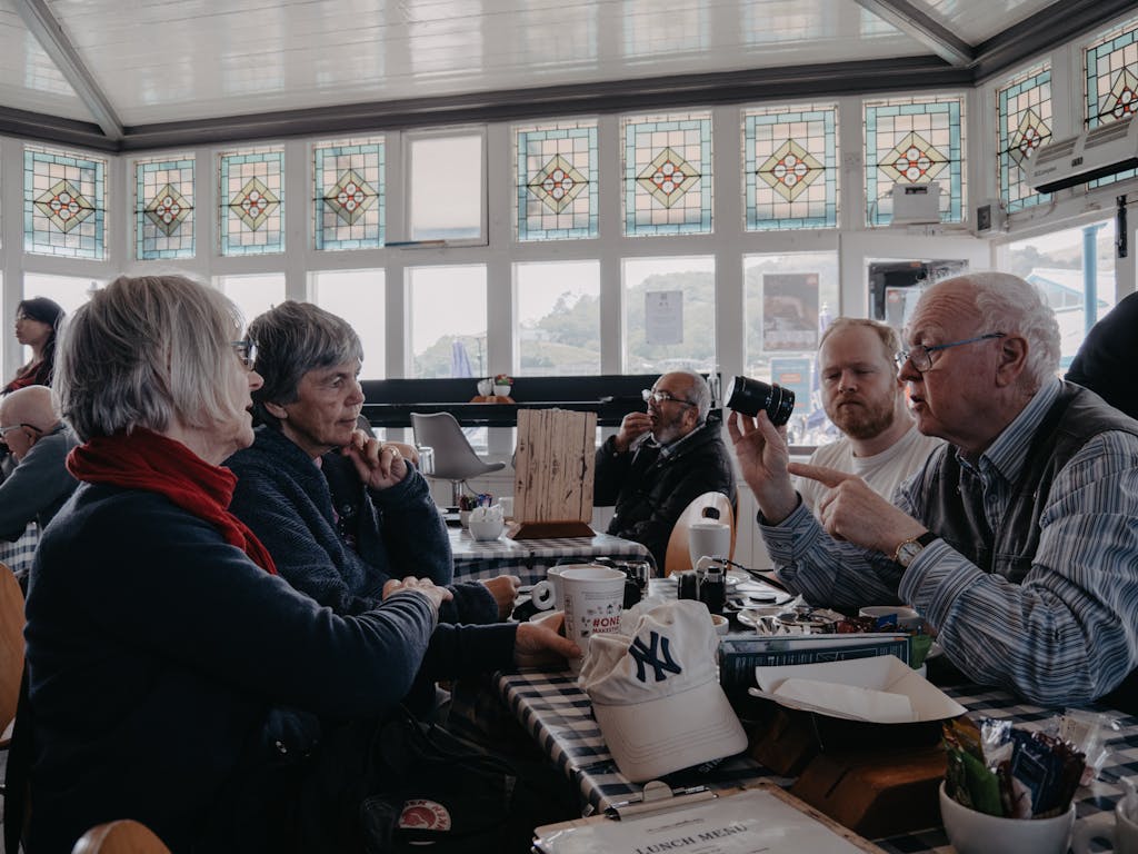 People Sitting by Table in Cafe